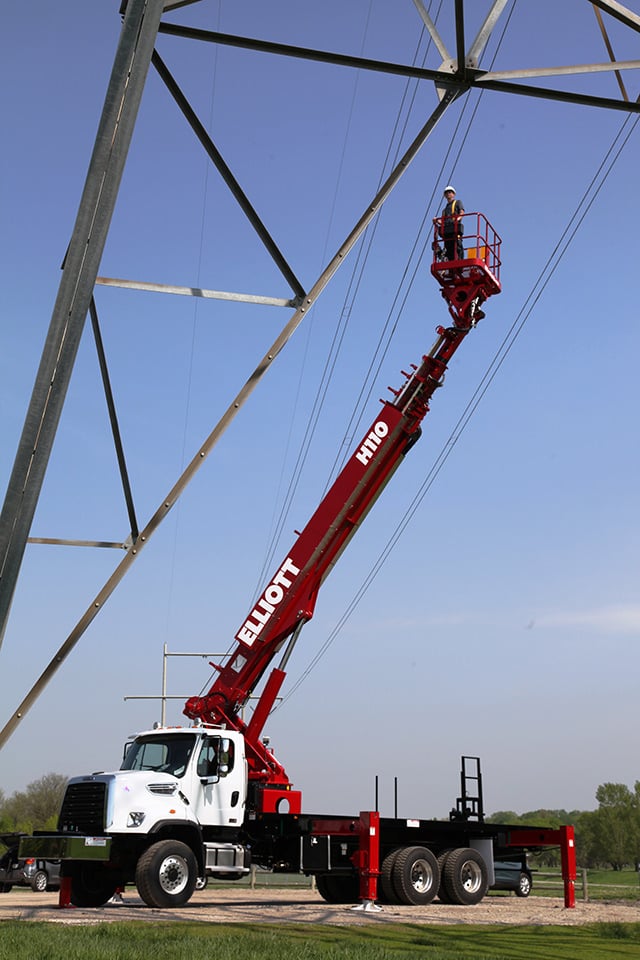 worker on hireach inspecting electrical wiring