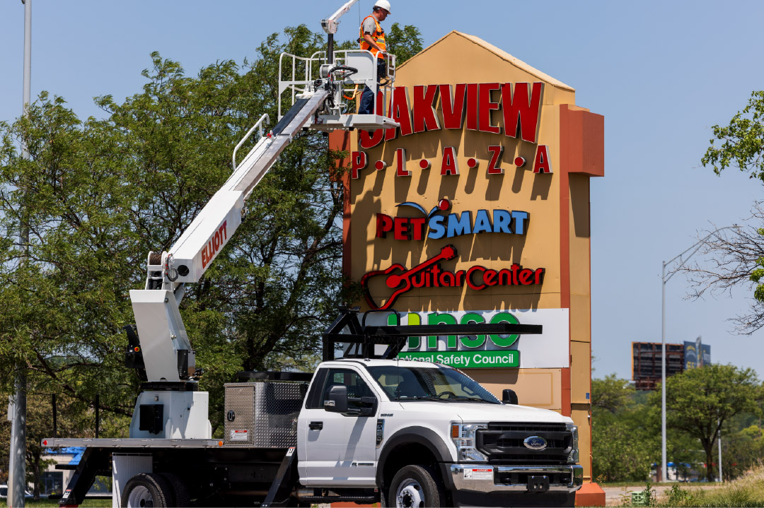crane truck in front of sign
