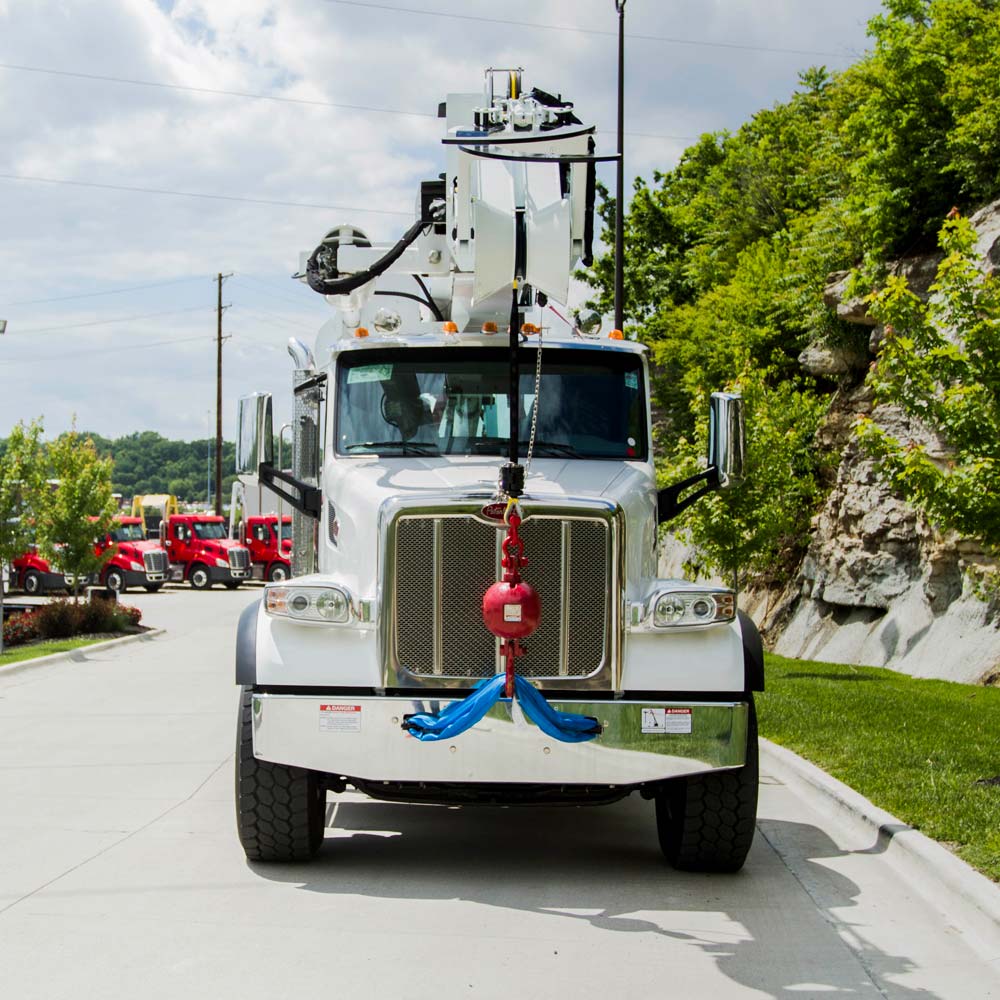 d 115 truck reaching up to phone poles with work team posing in front
