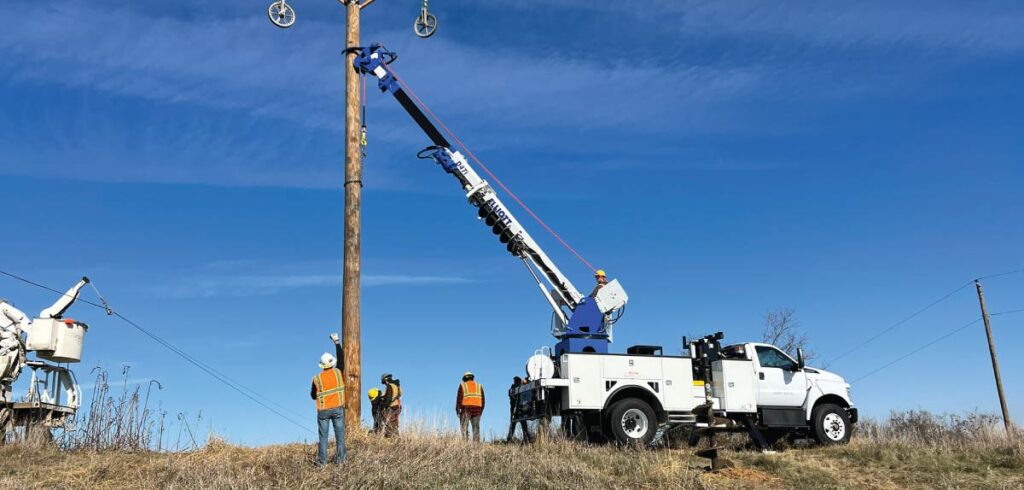 Elliot workers performing maintenance on a telephone pole and wiring
